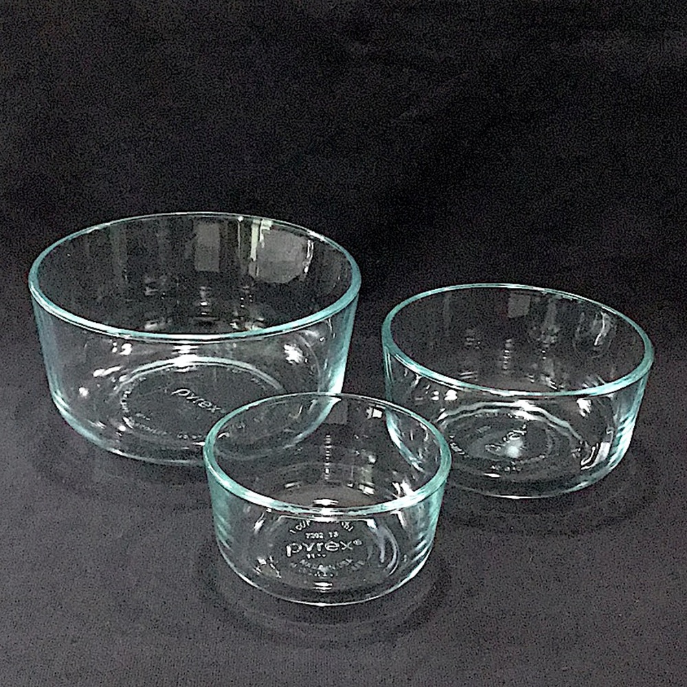 Set of three (3) aqua Pyrex bowls.